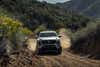 2024 Toyota Tacoma pickup truck first drive: a white truck driving through a dirt road