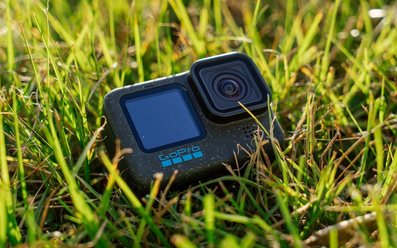 The GoPro Hero 12 Black sits on green grass.