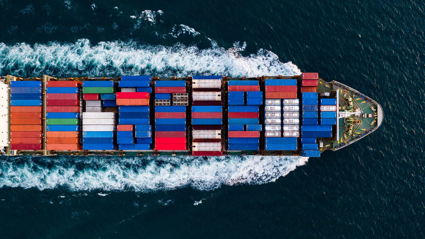 shipping containers on ship sailing through the sea